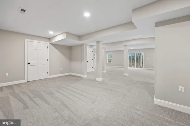 a view of a house with a big yard and large trees