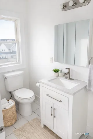 a bathroom with a sink toilet and window
