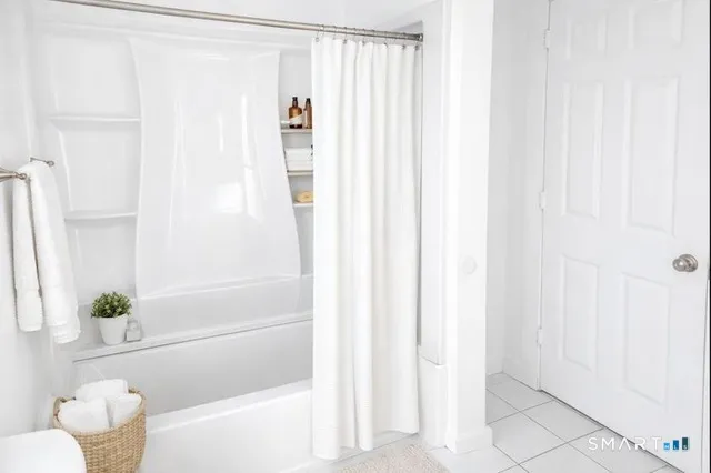 a bathroom with a shower curtain and a sink