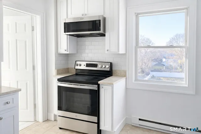 a kitchen with a stove and a microwave