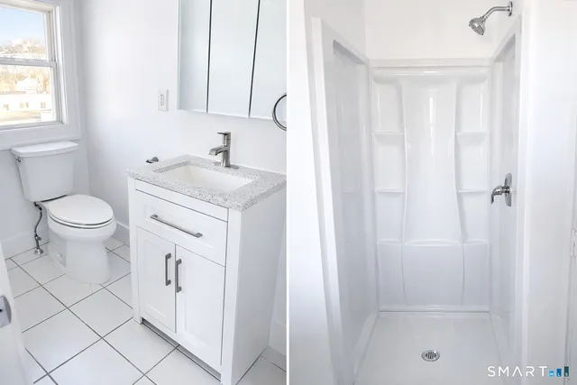 a bathroom with a granite countertop sink toilet and shower