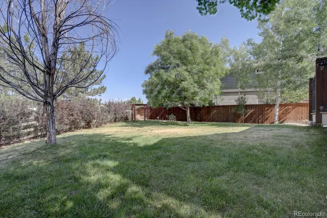 a view of a house with a yard and sitting area