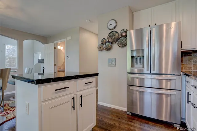 a kitchen with stainless steel appliances granite countertop a refrigerator and a stove