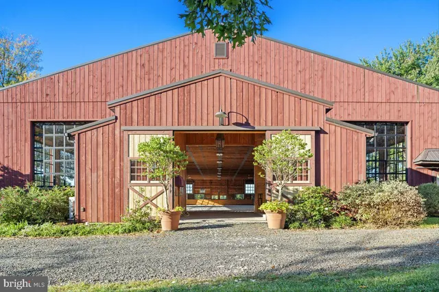 an empty room with windows and ceiling fan