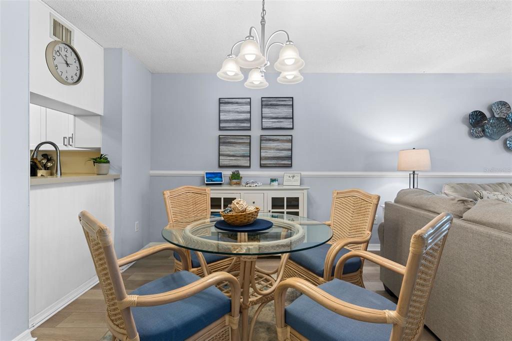 16308 Gulf Boulevard, Unit 209 Redington Beach, FL 33708 - Photo 12 of 54 a view of a dining room with furniture and a chandelier