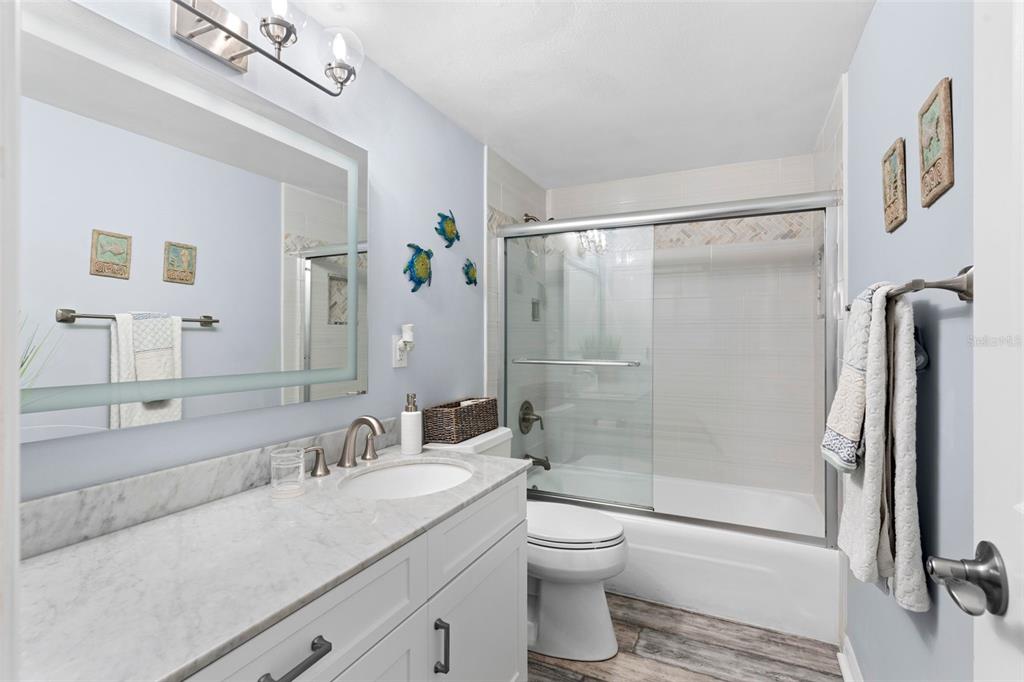 16308 Gulf Boulevard, Unit 209 Redington Beach, FL 33708 - Photo 19 of 54 a bathroom with a granite countertop sink toilet and shower