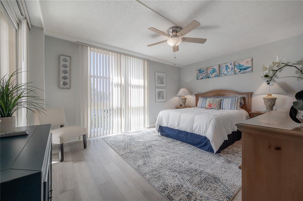 16308 Gulf Boulevard, Unit 209 Redington Beach, FL 33708 - Photo 21 of 54 a bedroom with a large bed and a chandelier