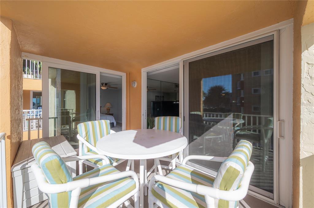 16308 Gulf Boulevard, Unit 209 Redington Beach, FL 33708 - Photo 26 of 54 a view of a patio with table and chairs and potted plants
