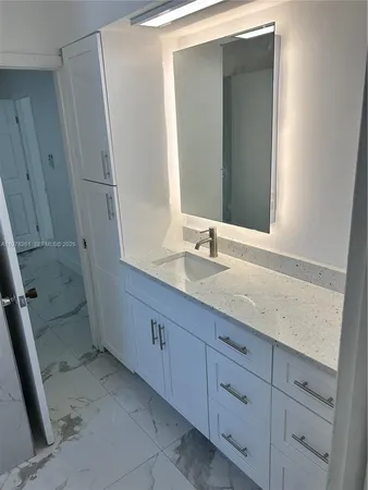 a bathroom with a double vanity sink and a mirror