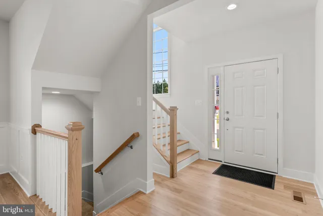 a view of entryway and hall with wooden floor