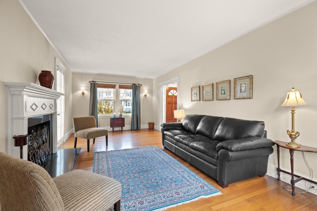 177 Nevada Street Newton, MA 02460 - Photo 14 of 40 a living room with furniture fireplace and a window