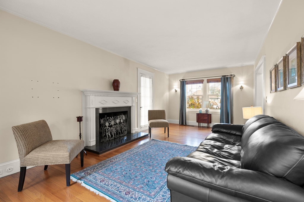 177 Nevada Street Newton, MA 02460 - Photo 15 of 40 a living room with furniture and a fireplace