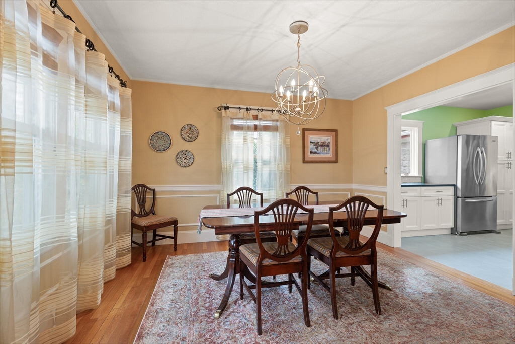177 Nevada Street Newton, MA 02460 - Photo 16 of 40 a view of a dining room with furniture and chandelier