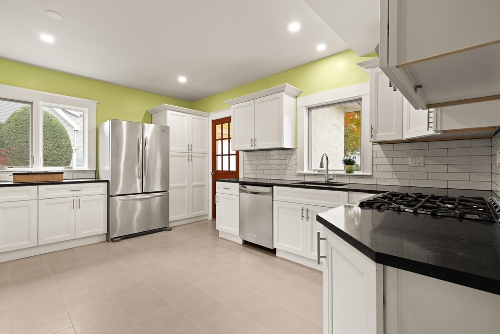 177 Nevada Street Newton, MA 02460 - Photo 18 of 40 a kitchen with a sink a stove a refrigerator and cabinets