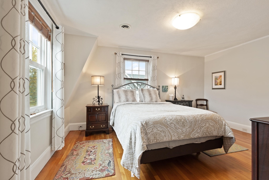 177 Nevada Street Newton, MA 02460 - Photo 29 of 40 a bedroom with a bed and wooden floor