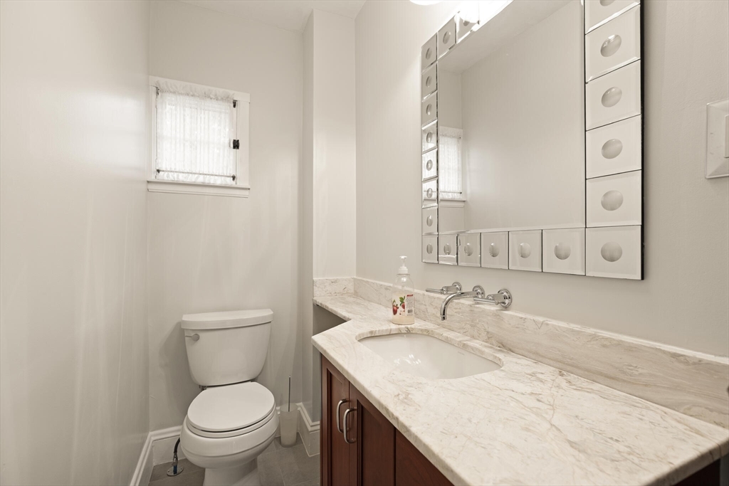177 Nevada Street Newton, MA 02460 - Photo 33 of 40 a bathroom with a granite countertop sink toilet and mirror