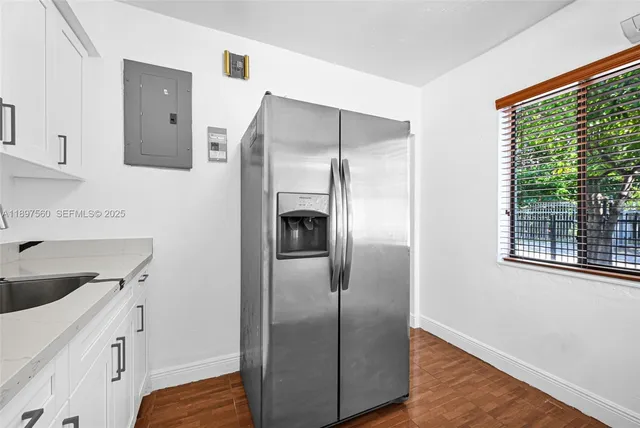 a kitchen with a refrigerator and a sink