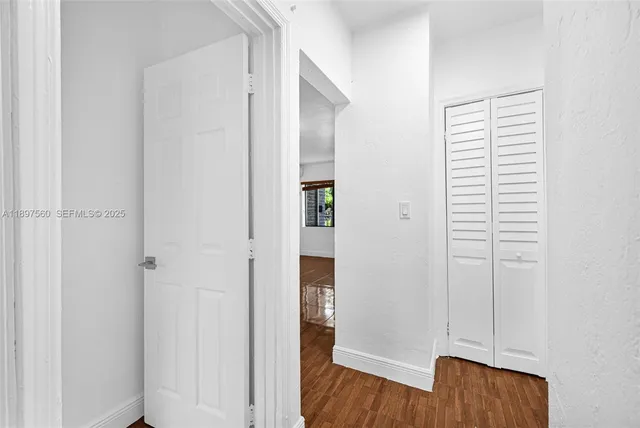 a view of hallway with wooden floor