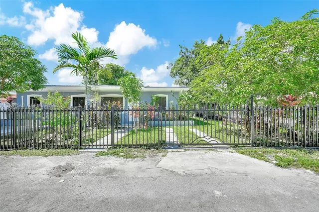 a view of a house with a garden and plants