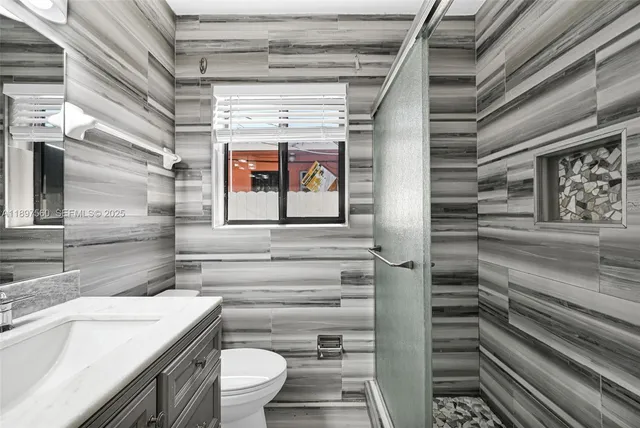 a bathroom with a toilet a sink and a shower