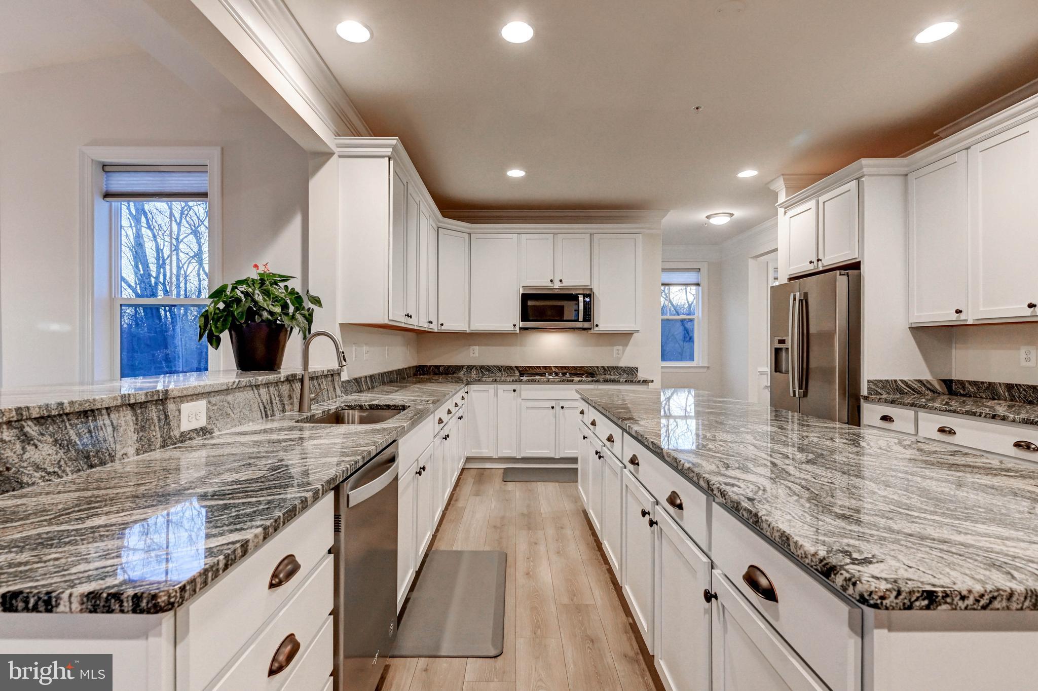 2613 Cotter Road Manchester, MD 21102 - Photo 14 of 26 a large kitchen with stainless steel appliances granite countertop a sink counter space cabinets and a large window