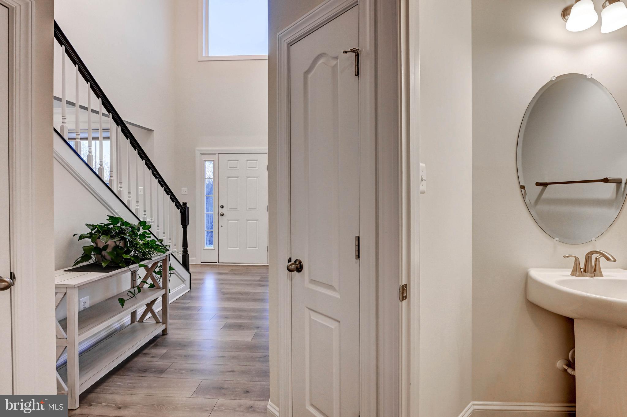 2613 Cotter Road Manchester, MD 21102 - Photo 18 of 26 a hallway with white doors wooden floor and front door