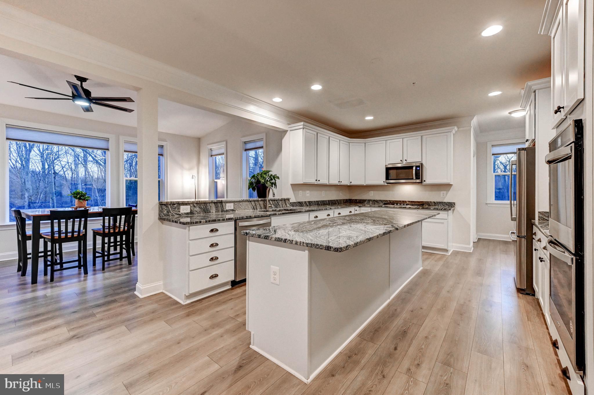 2613 Cotter Road Manchester, MD 21102 - Photo 2 of 26 a kitchen with white cabinets and stainless steel appliances