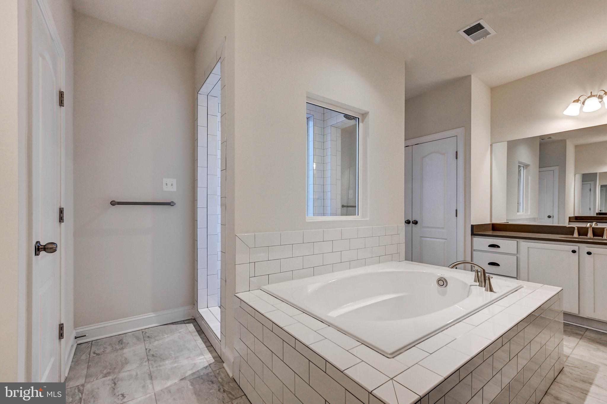 2613 Cotter Road Manchester, MD 21102 - Photo 21 of 26 a bathroom with a tub a sink and a mirror