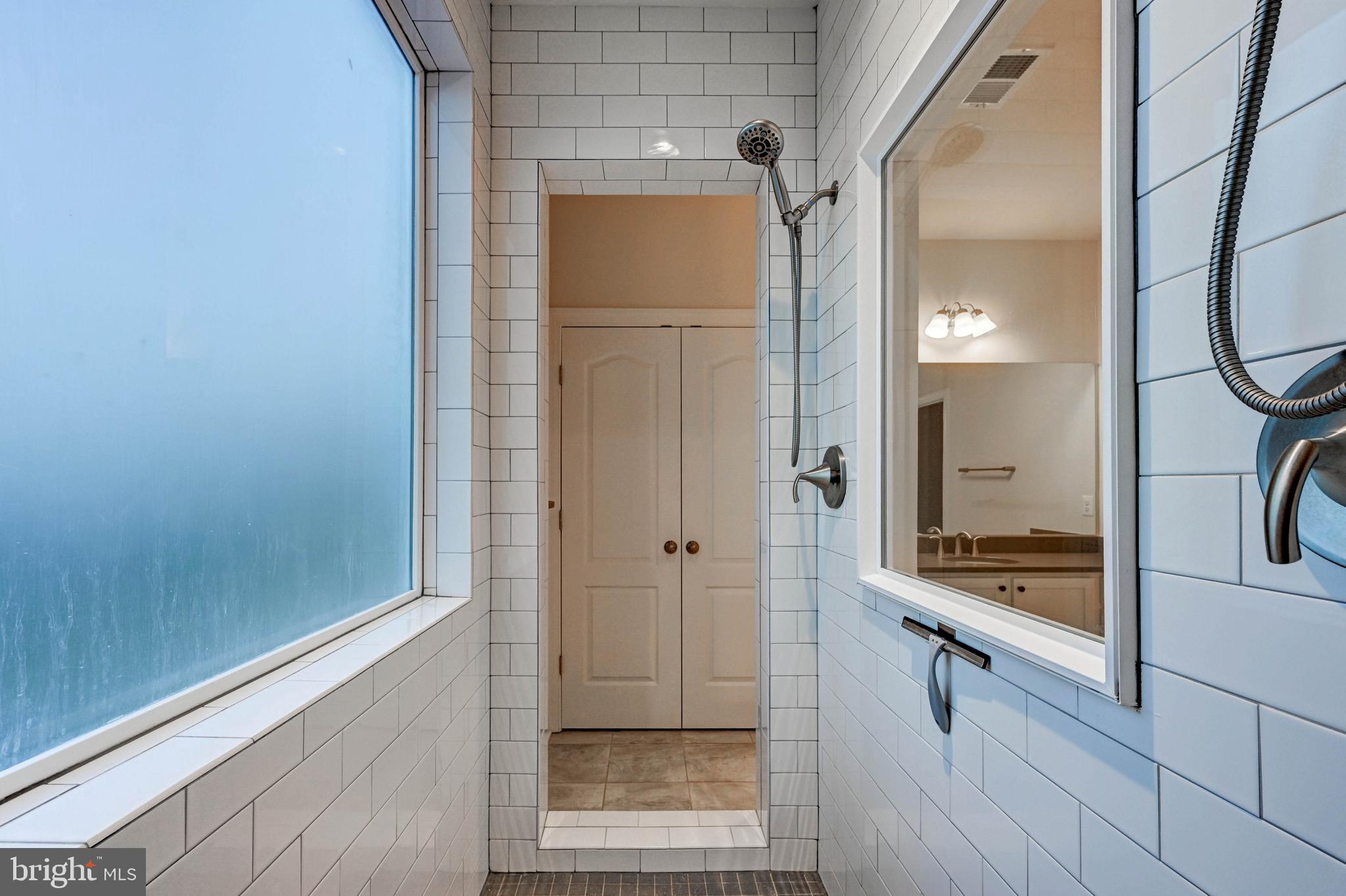2613 Cotter Road Manchester, MD 21102 - Photo 22 of 26 a view of a bathroom with a glass door shower and mirror