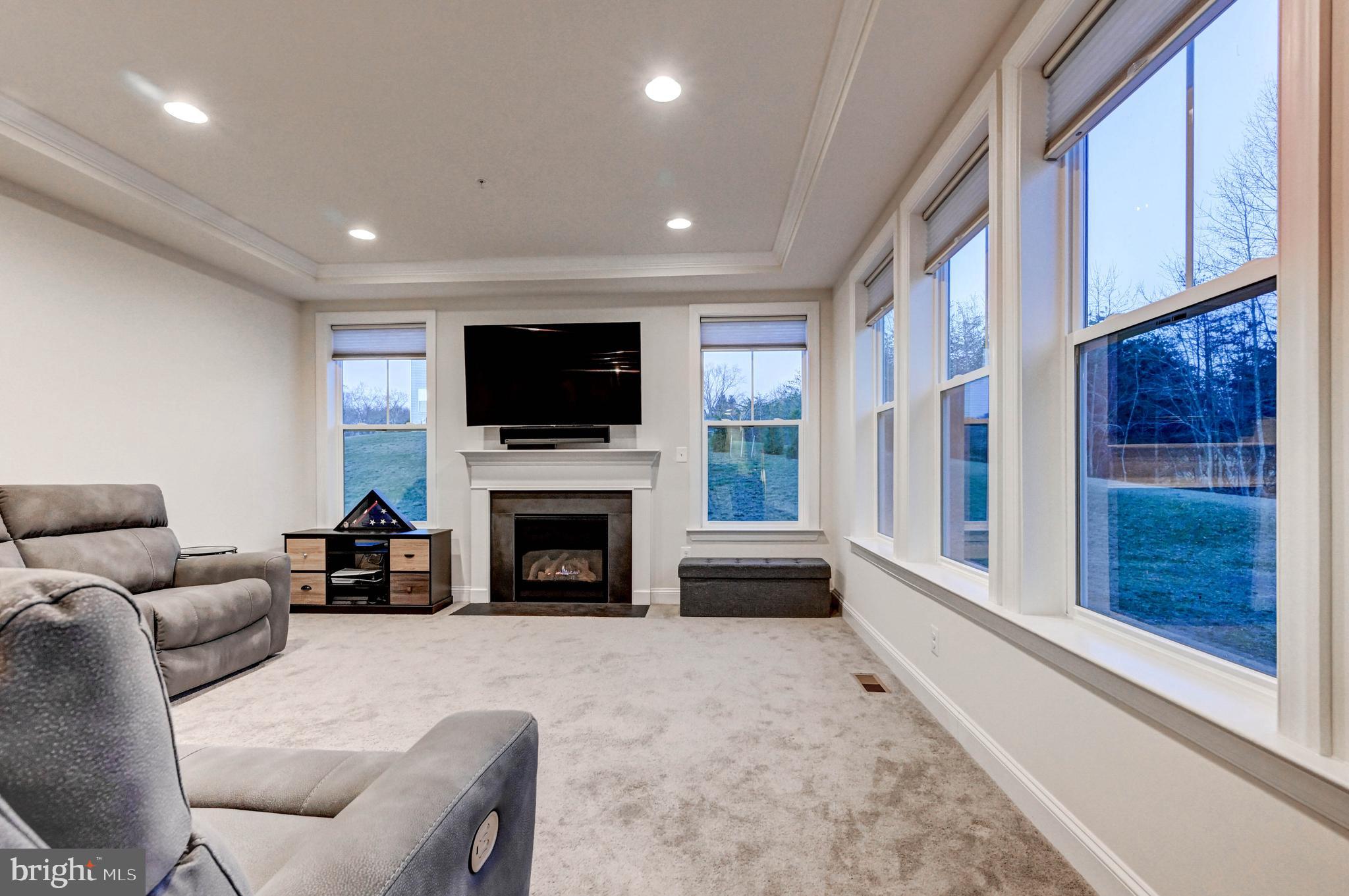 2613 Cotter Road Manchester, MD 21102 - Photo 6 of 26 a living room with furniture a fireplace and a flat screen tv