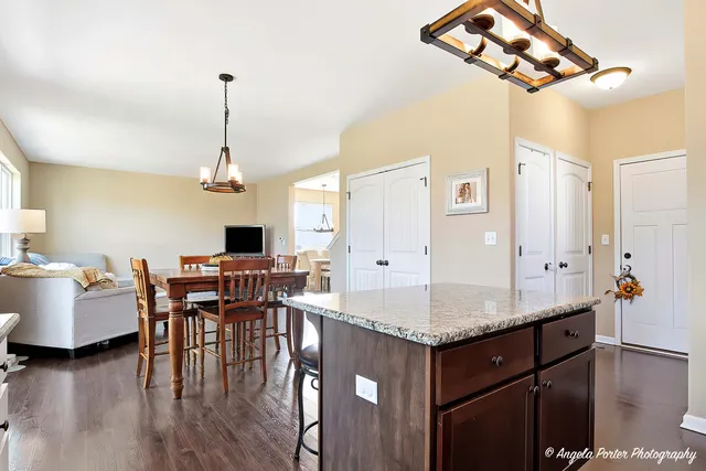 a kitchen with a counter space cabinets and wooden floor