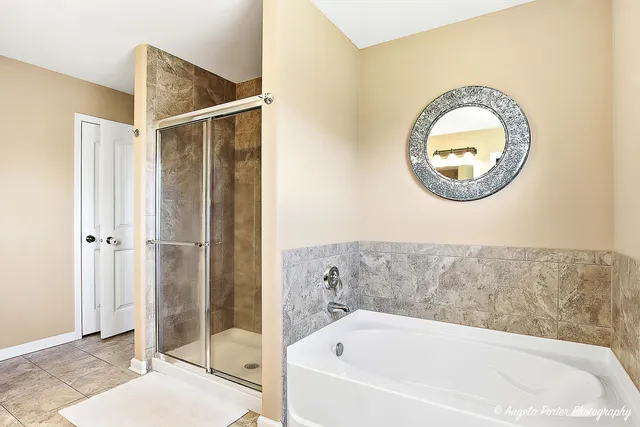 a bathroom with a tub and shower