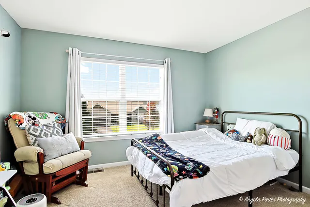 a bedroom with bed and a window