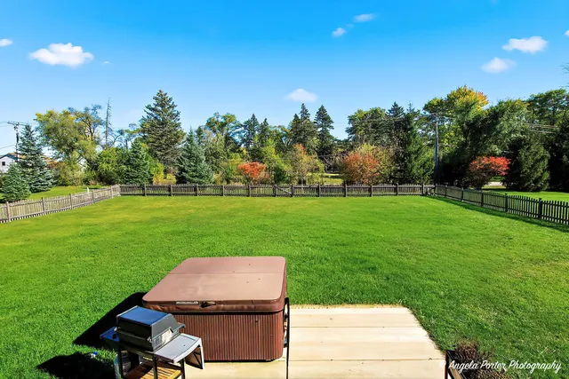 a view of a backyard with sitting area