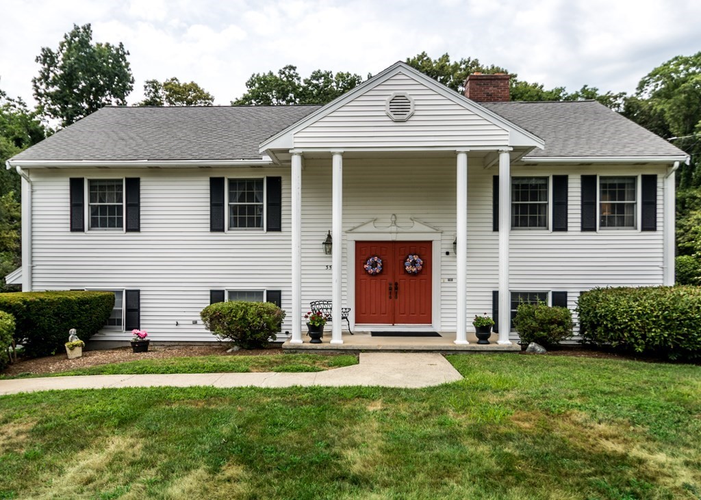 35 Woodchester Road Waltham, MA 02451 - Photo 1 of 39 a front view of a house with a yard and garage