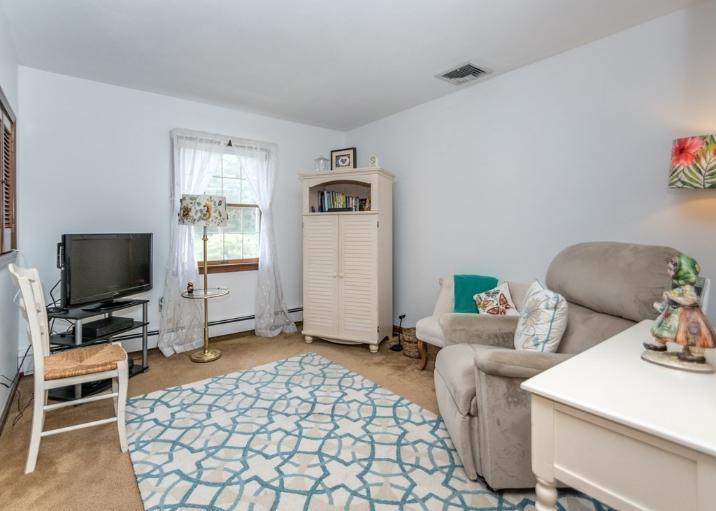 35 Woodchester Road Waltham, MA 02451 - Photo 14 of 39 a living room with furniture and a flat screen tv