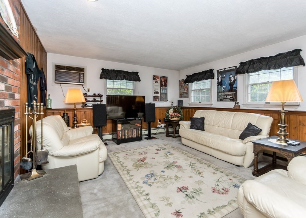 35 Woodchester Road Waltham, MA 02451 - Photo 16 of 39 a living room with furniture and a flat screen tv