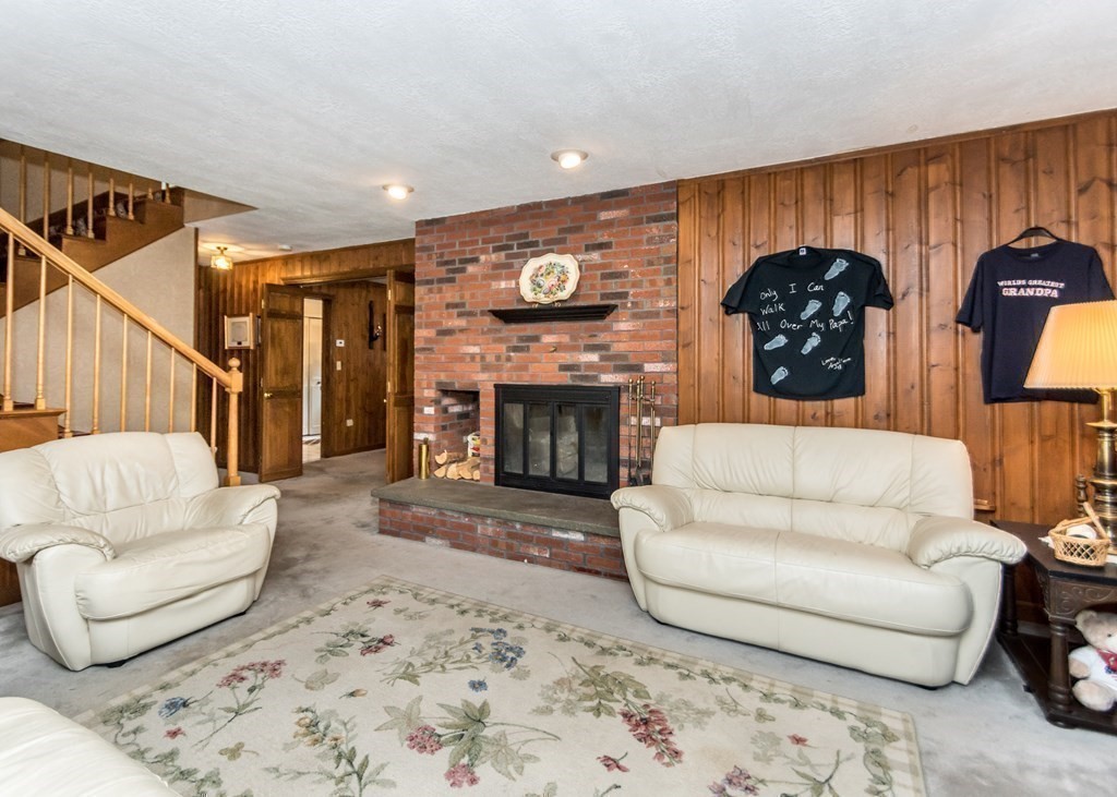 35 Woodchester Road Waltham, MA 02451 - Photo 17 of 39 a living room with furniture and a fireplace