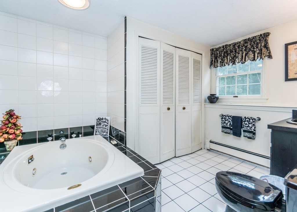 35 Woodchester Road Waltham, MA 02451 - Photo 22 of 39 a bathroom with a bathtub a sink and a shower