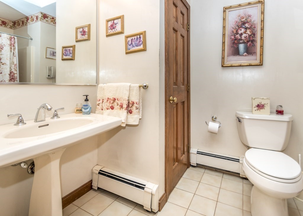 35 Woodchester Road Waltham, MA 02451 - Photo 23 of 39 a bathroom with a sink mirror vanity and toilet