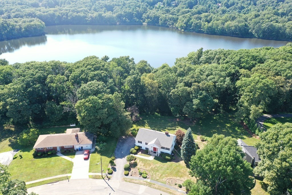 35 Woodchester Road Waltham, MA 02451 - Photo 32 of 39 a view of a lake with couches and wooden fence