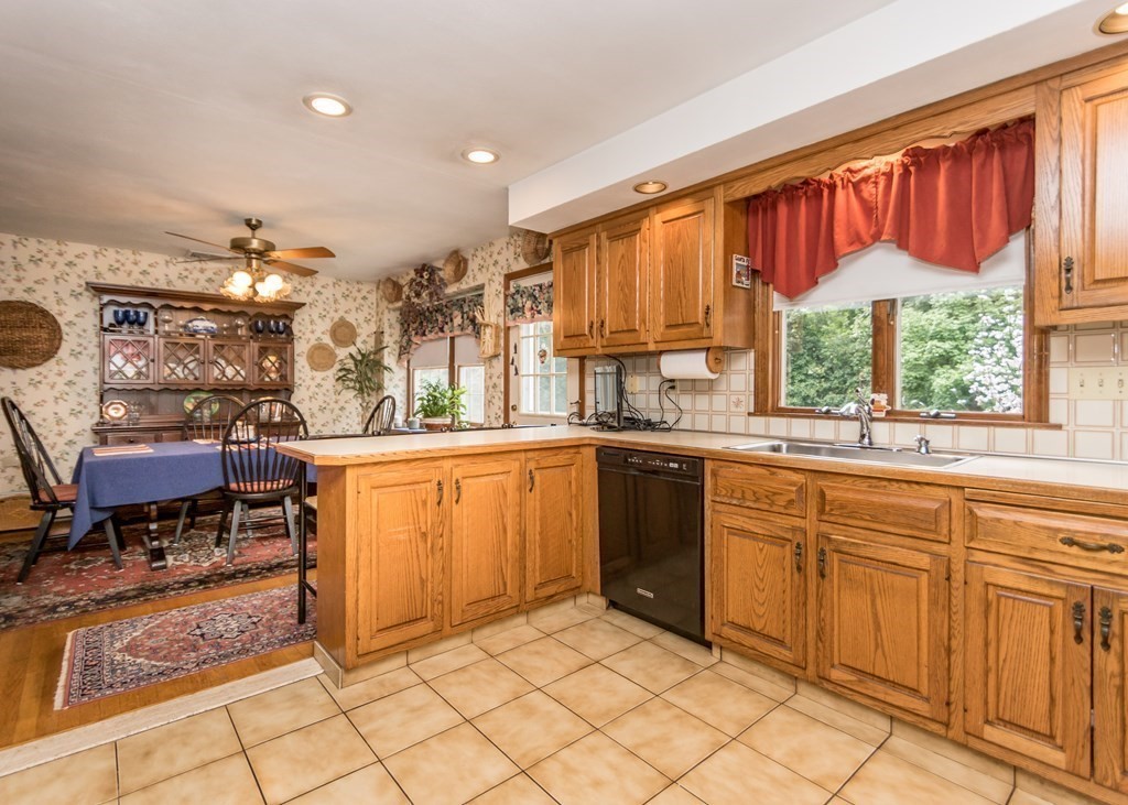 35 Woodchester Road Waltham, MA 02451 - Photo 5 of 39 a kitchen with granite countertop a stove a sink and a refrigerator