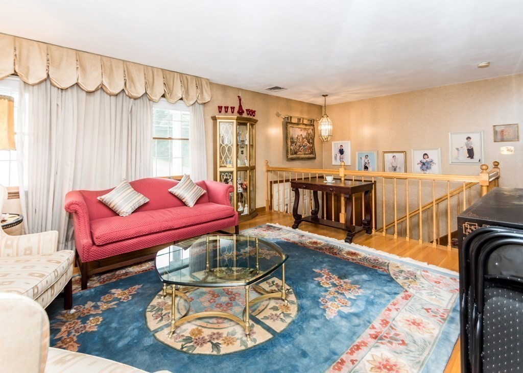 35 Woodchester Road Waltham, MA 02451 - Photo 10 of 39 a living room with furniture a rug and a chandelier