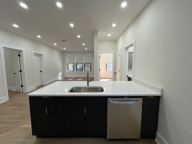 a kitchen with a sink and mirror