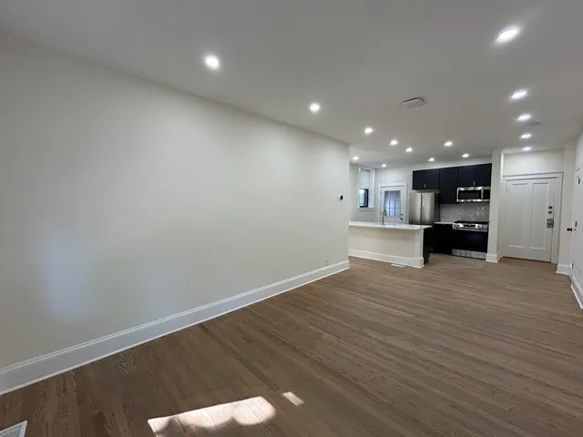 a view of kitchen with refrigerator and window