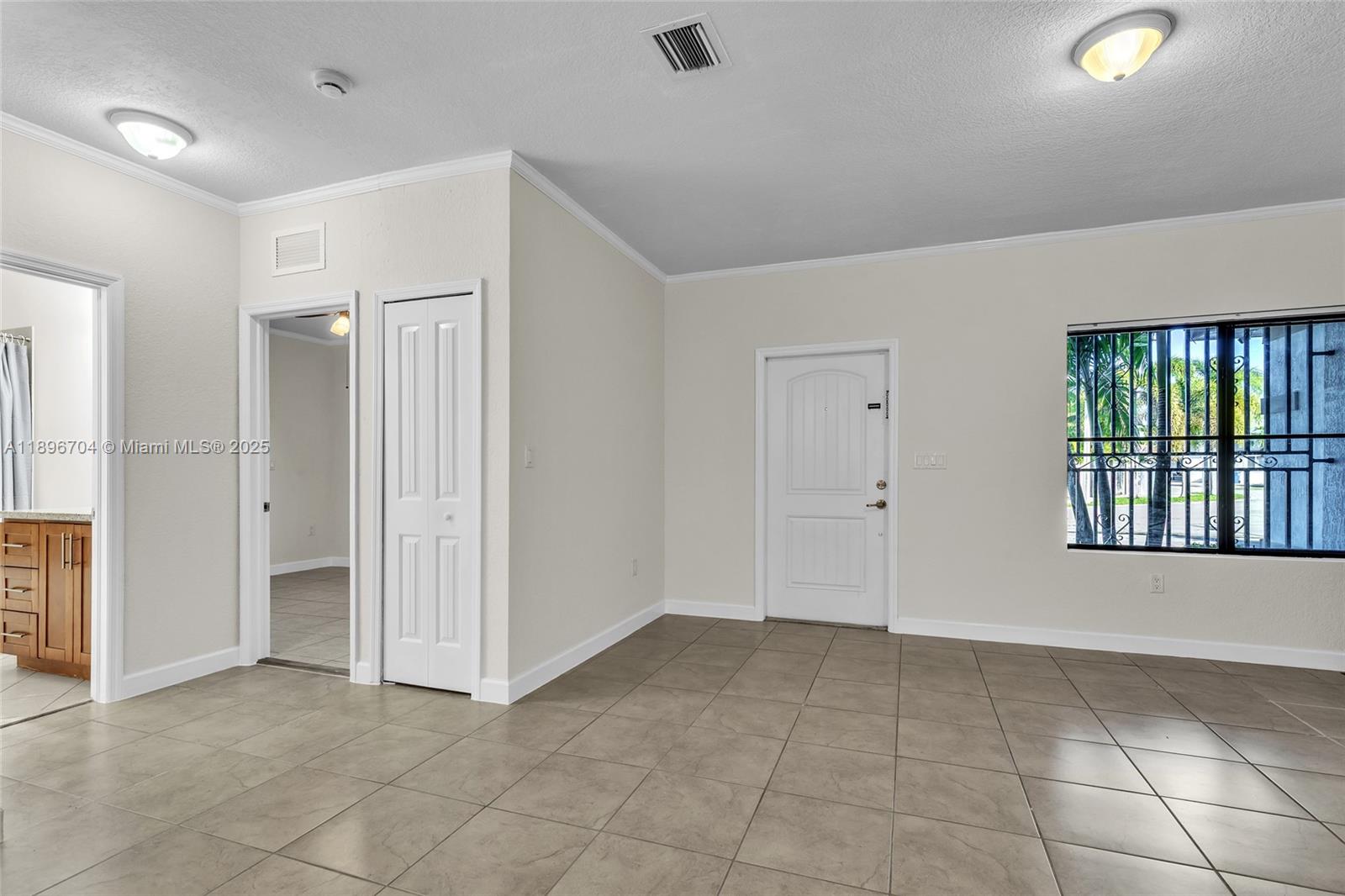 27109 Southwest 133rd Court Homestead, FL 33032 - Photo 12 of 48 a view of an empty room with a window