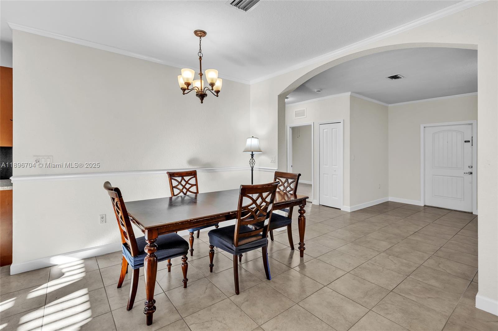 27109 Southwest 133rd Court Homestead, FL 33032 - Photo 16 of 48 a view of a dining room with furniture and chandelier