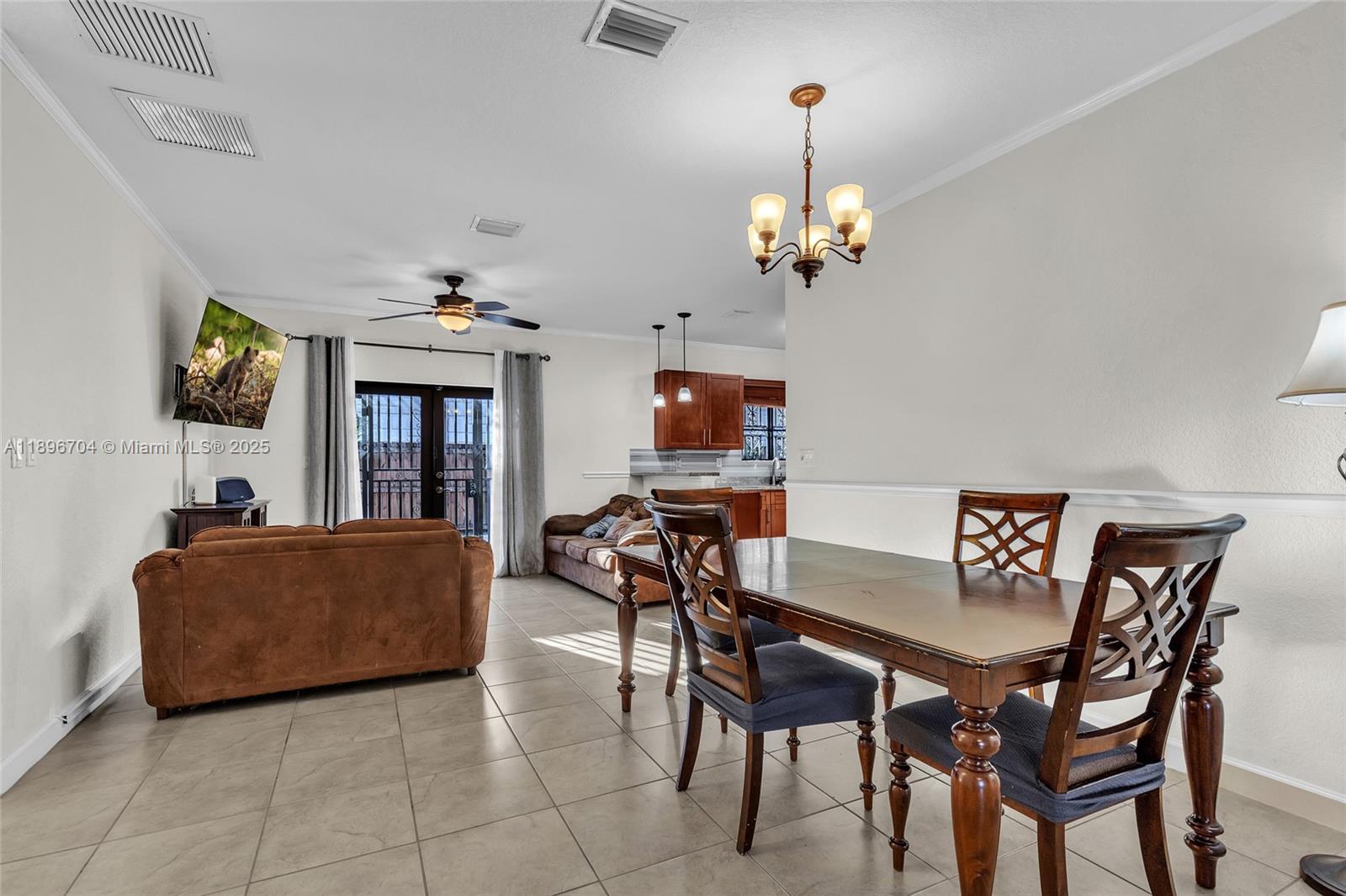 27109 Southwest 133rd Court Homestead, FL 33032 - Photo 18 of 48 a view of a dining room with furniture and chandelier