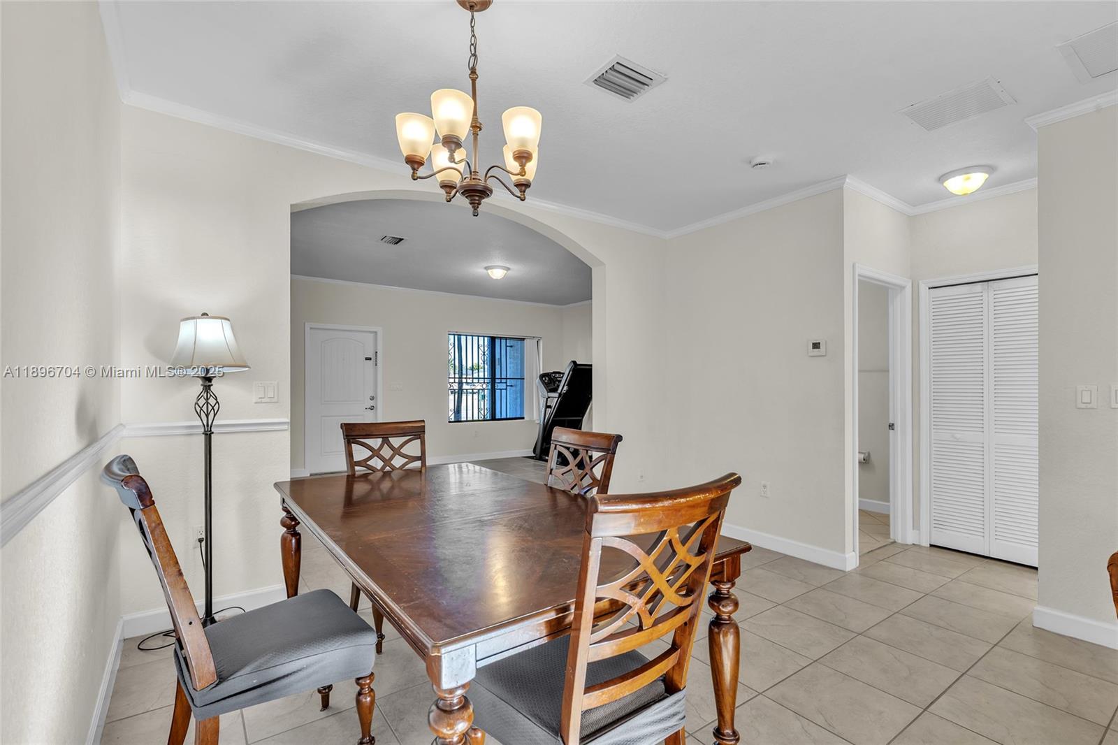 27109 Southwest 133rd Court Homestead, FL 33032 - Photo 19 of 48 a view of a dining room with furniture and chandelier