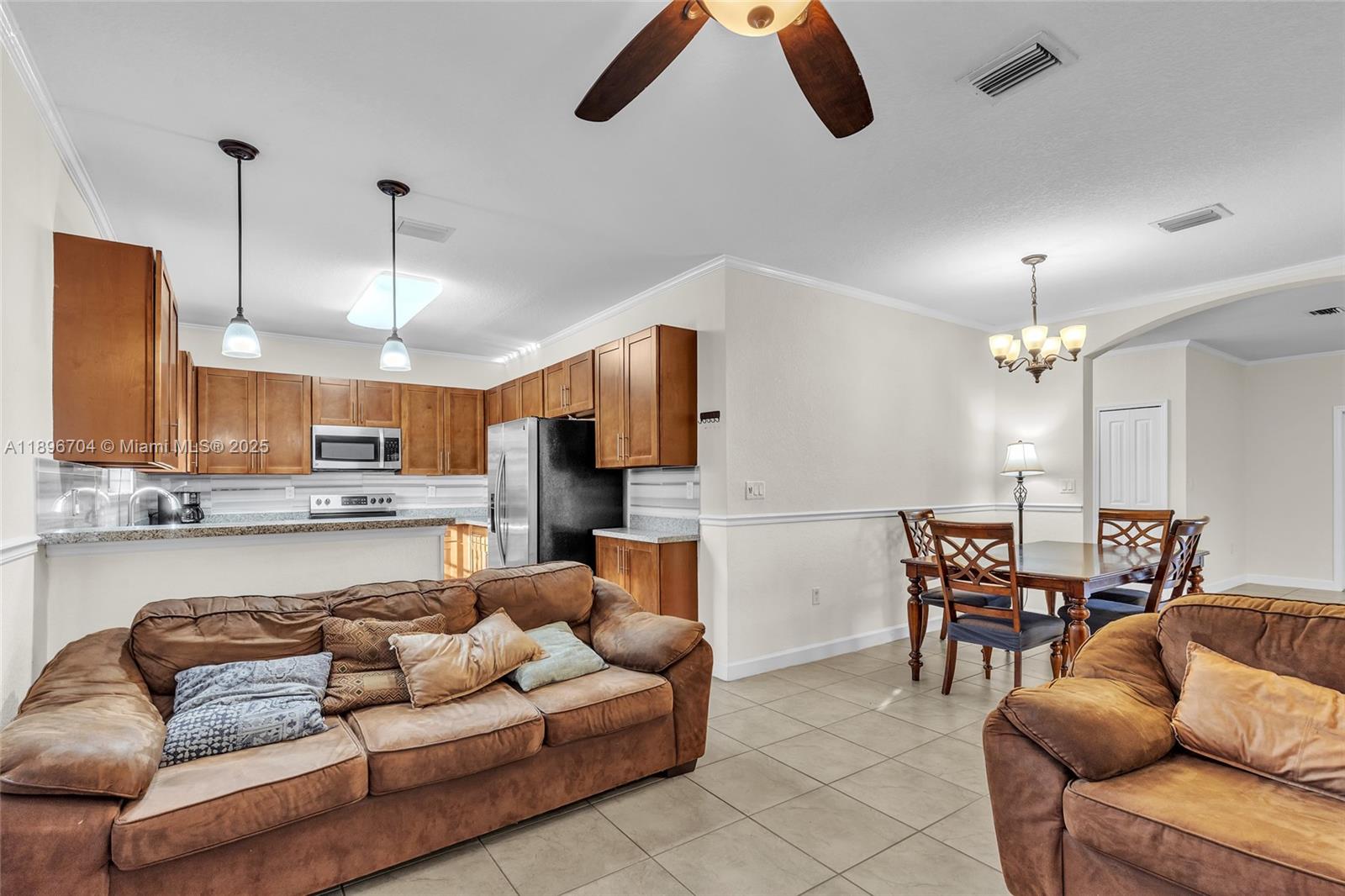 27109 Southwest 133rd Court Homestead, FL 33032 - Photo 21 of 48 a living room with furniture kitchen view and a chandelier